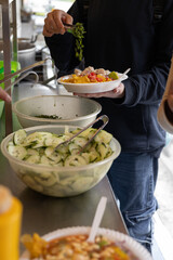  Preparing a fresh plate of cevichocho with chochos, vegetables, and seasonings, perfect for themes like Ecuadorian cuisine, traditional dishes, and street food.