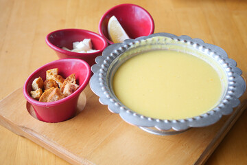 Delicious lentil soup served with crispy bread and lemon wedges