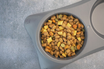 Pet food bowl filled with kibble in a modern kitchen setting