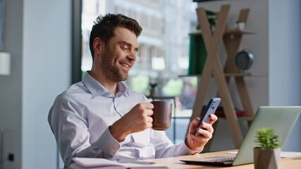 Office man holding coffee cup browsing social media at smartphone closeup.  - Powered by Adobe