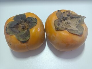 Two of persimmon fruit isolated on white background, group of fruits, couple