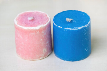 Two beautiful new candles in pink and blue colors, fireless, are shown against a white background.