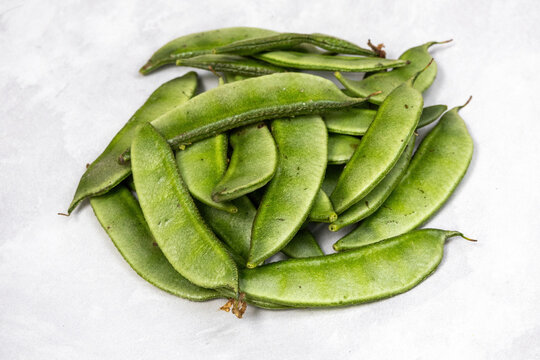 Fresh green hyacinth beans, isolated on a white background.