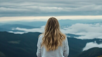 Fototapeta premium Young woman gazing into the vast mountains and clouds creating a moment of serenity and reflection : Generative AI