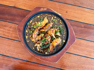 Sizzling Stir-fried Seabass belly with Fingerroot, famous thai spicy seafood. Thai seafood recommend menu 