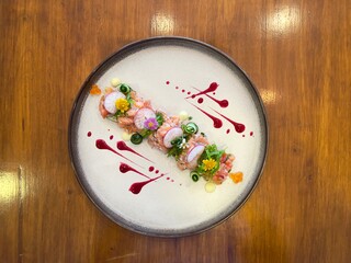 Salmon tartare salad with beautiful decorations, fine dining food. Fusion food. 