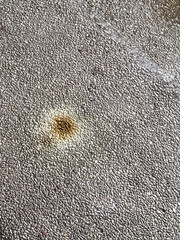 Top-down shot of a stained slab of textured grungy worn-out concrete step.  