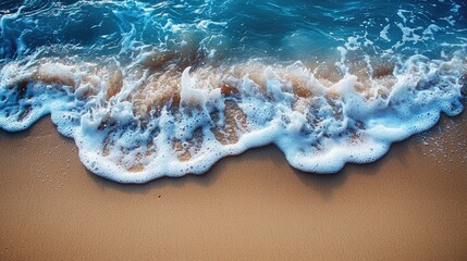 Gentle ocean waves lapping against a sandy beach under a clear blue sky, evoking tranquility