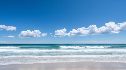 Obraz premium Tranquil Beach Scene with Gentle Waves Lapping at the Shore Under a Bright Blue Sky with Fluffy Clouds : Generative AI