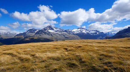 Obraz premium Stunning view of vast mountain landscape under a blue sky with fluffy clouds on a sunny day : Generative AI