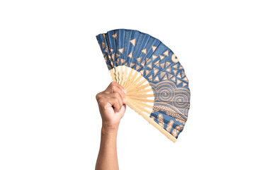 Hand holding Traditional folding hand fan with batik motif isolated on white background