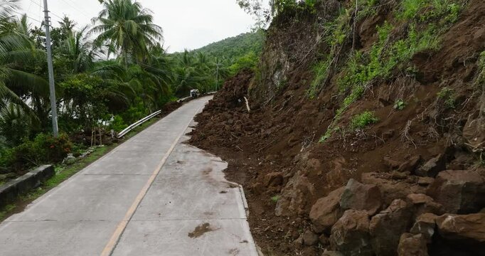 Mountain soil collapse in half of the highway. Landslides due to heavy rainfall. Camiguin, Philippines.