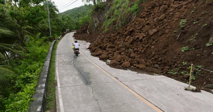 Mudslides from mountain cliff block the mountain road. Camiguin, Philippines.