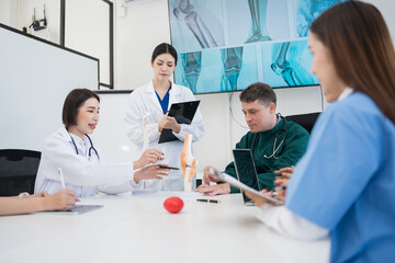 Fototapeta premium A close-up image shows a doctor working on a laptop computer.
