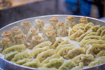 Close-up of steaming dumplings in a steamer at a breakfast shop