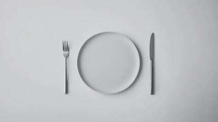 Empty Plate and Cutlery on Light Background