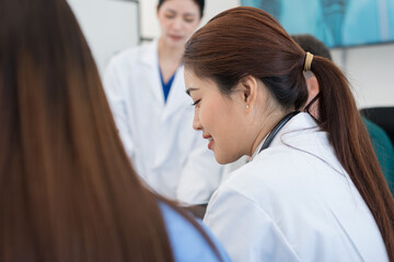 Fototapeta premium Multi-ethnic healthcare team meets about surgery at pharmaceutical company hospital