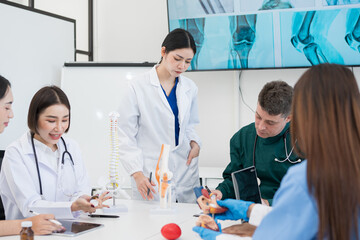 Male and female doctors are having a meeting in a hospital room.