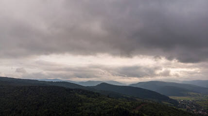 Majestic Mountains, Lush Green Forests, And Dramatic Clouds With The Sun Casting A Golden Glow. Aerial View Capturing The Stunning Beauty Of Nature From A Bird&rsquo;s-Eye Perspective.	
