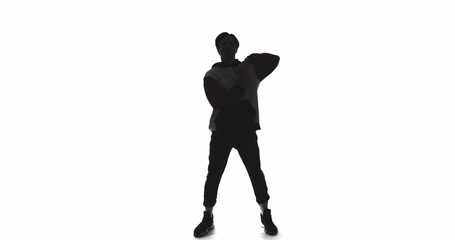 Dancer silhouette. Street style. Dark contrast outline of cool guy performing freestyle movements isolated on white empty space background.