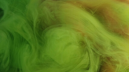 Multicolored fog. Marble cloud. Elegant glowing veil curls of green paint stir in water. Relaxing hypnotic atmosphere defocused swirling abstract background.