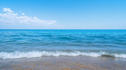 Beautiful tropical ocean view with clear blue water and gentle waves caressing the sandy beach under a bright sky : Generative AI