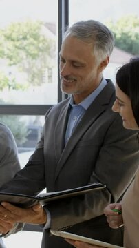 Couple signing the agreement to get their new house