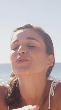 Woman blowing a kiss in front of her smartphone