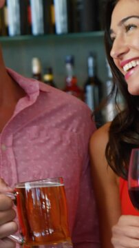 Portrait of friends talking and holding drinks