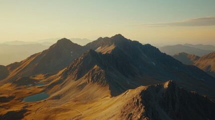 Majestic mountain range at sunset with golden peaks and serene lakes in the foreground