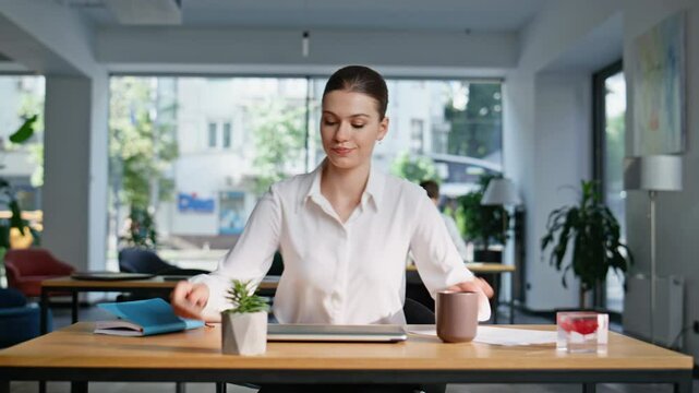 Confident lady starting workday sit down at desk office closeup. Elegant woman