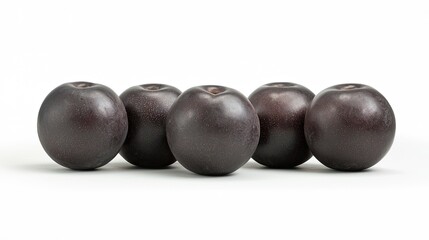 Five glossy black plums arranged in a row on a white background, perfect for food photography