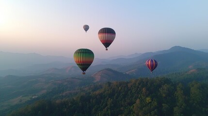 Naklejka premium Hot air balloons drift serenely above rolling green mountains