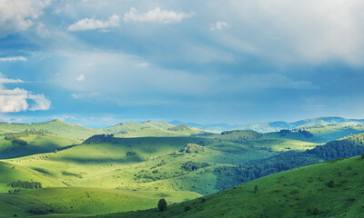 Fototapeta premium View of a summer day in the mountains, green meadows, mountain slopes and hills, countryside 