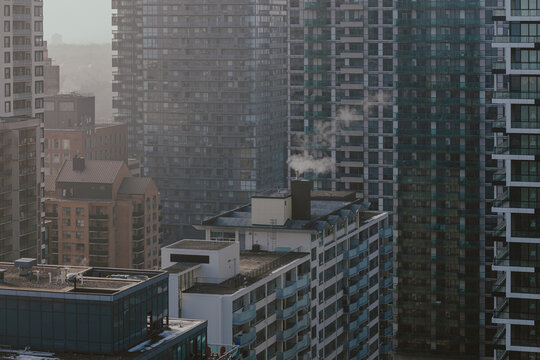 Toronto, Canada December 28, 2024: Toronto high-rise residential buildings with steam rising from rooftops on a cold morning