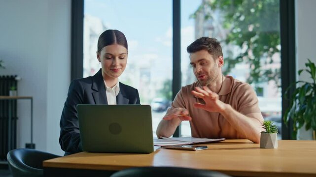 Financial advisor talking investor showing data at laptop in office closeup.