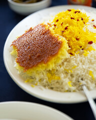 Authentic Persian Tahdig rice dish with crispy golden bottom and saffron rice served on a white plate