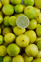 One half-lime texture on yellow lime in a vertical background. Top view overripe lime texture with concept of fresh ingredient, sour cooking, and cuisine. Abstract food texture of yellow limes.
