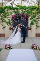 The beautiful wedding ceremony featured a lovely bride and charming groom sharing a tender kiss...