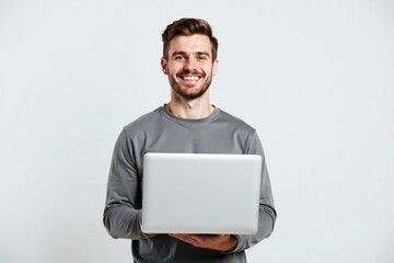 Young man holding a laptop.  Casual or professional setting.  Suitable for technology, business, education, and modern lifestyle themes.