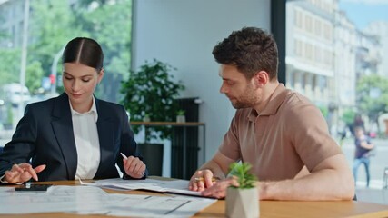 Woman accountant explaining report to man in office financial company closeup.