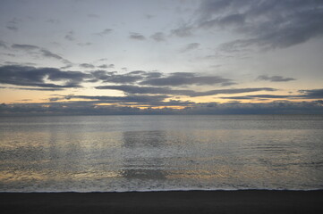 Tranquil Dawn: A Serene Ocean Reflecting the First Light of the Day.