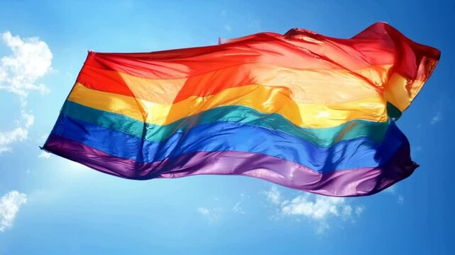 A rainbow flag is flying in the sky