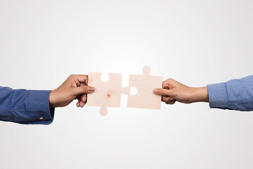 businessman holds in hand a jigsaw puzzle for partnership teamwork, collaborate of partner and...