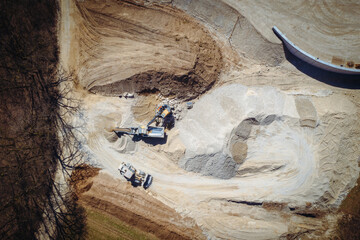 Birds View of Construction Material Landfill with Machinery Processing Sand and Gravel Near Highway...