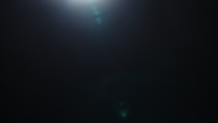 Real optic lens flare over black background for overlay or background