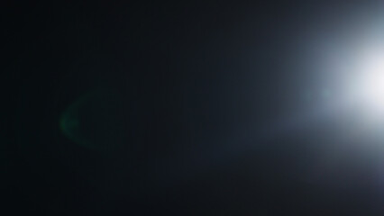 Real optic lens flare over black background for overlay or background