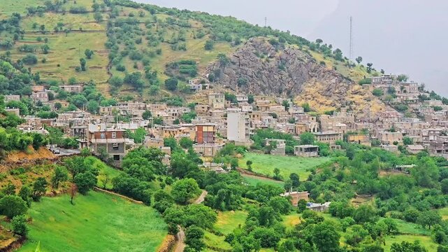 Lush green hills under a misty sky, a serene escape in a peaceful village.
📍Novin, Hawraman Takht 