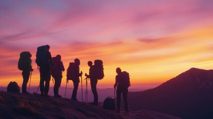 Obraz premium Hikers enjoy a breathtaking sunset view from a mountain peak after a long trek in nature