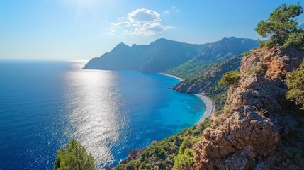 Fototapeta premium Verdant mountains under a bright, sunny sky, with the clear sea sparkling in the sunlight. 